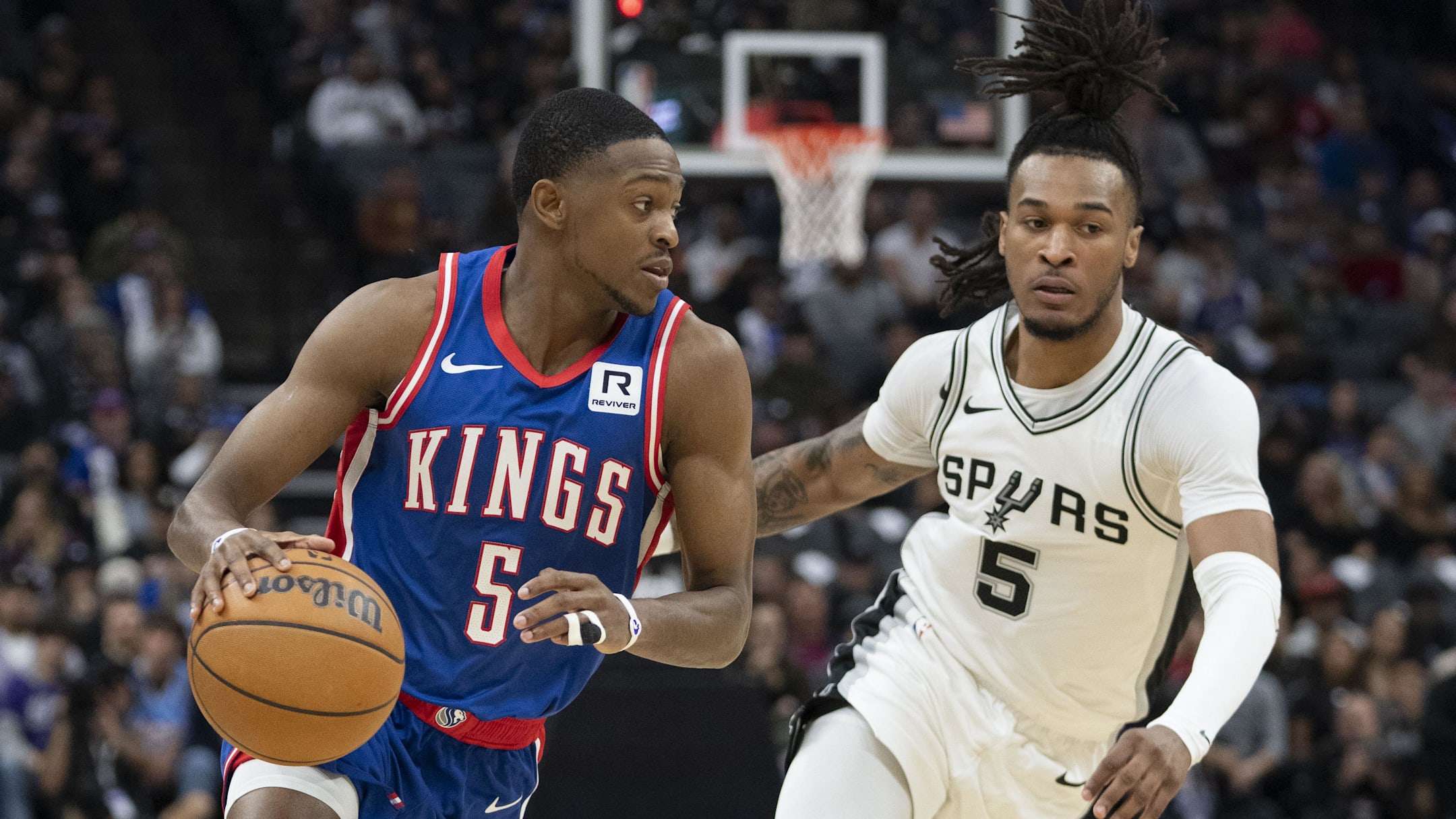 December 1, 2024; Sacramento, California, USA; Sacramento Kings guard De'Aaron Fox (5) dribbles the basketball against San Antonio Spurs guard Stephon Castle (5) during the second quarter at Golden 1 Center. Mandatory Credit: Kyle Terada-Imagn Images | Kyle Terada-Imagn Images